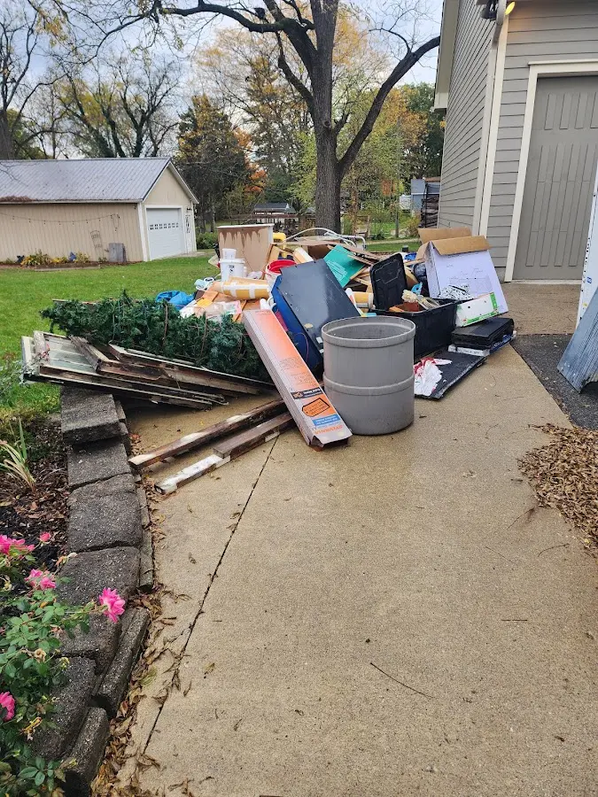 Dumpster being loaded with debris for Commercial Dumpster Rental in Hickory Hills